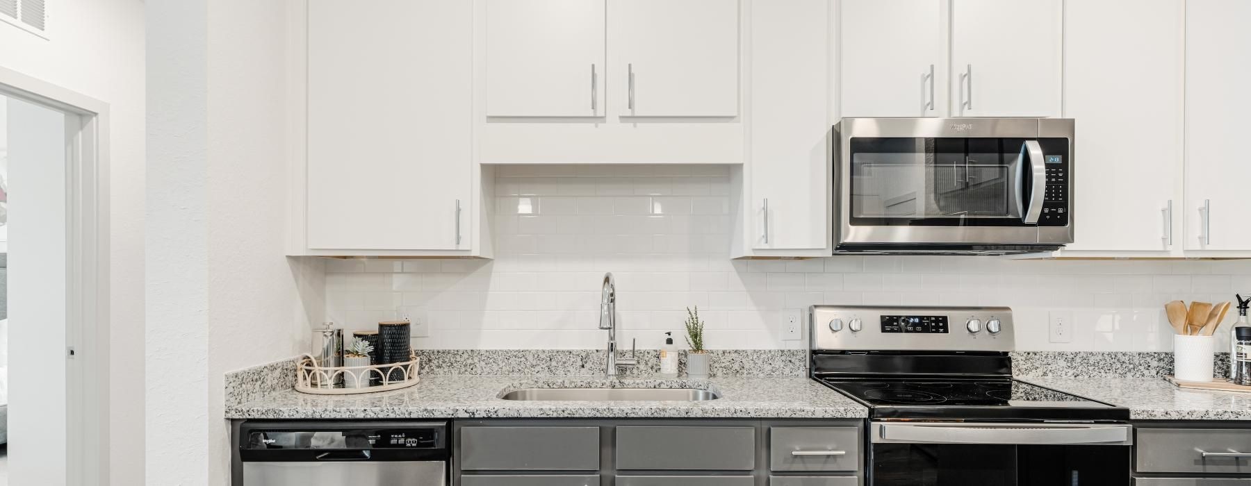 a kitchen with white cabinets