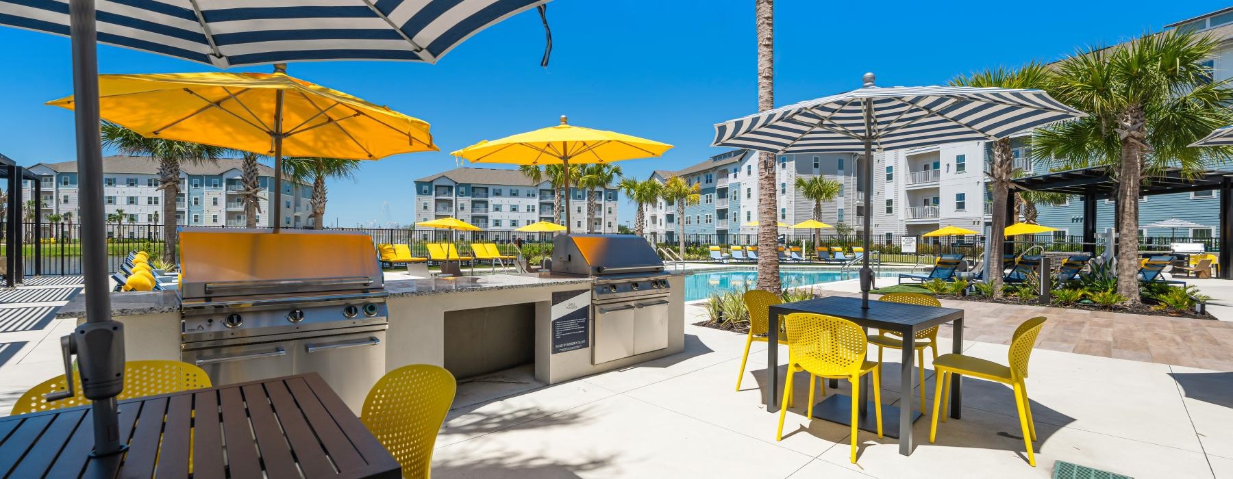 a patio with tables and chairs and umbrellas