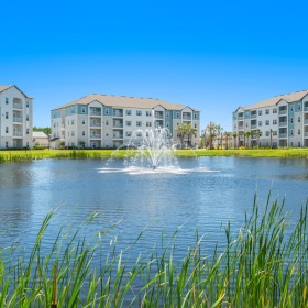 Settle into comfort at Atlas at the Loop a fountain in a pond